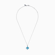 The Ocean Bleu 14K White Gold Blue Topaz and Diamond Pendant features a delicate chain and a four-petal flower blue topaz pendant accented with sparkling gemstones and a central diamond, set against a white background.