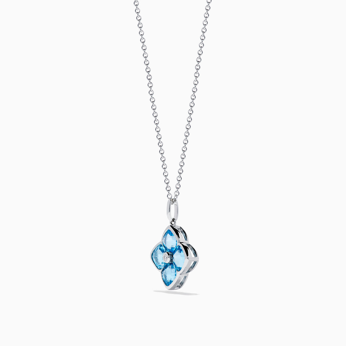 The Ocean Bleu 14K White Gold Blue Topaz and Diamond Pendant features a delicate chain and a four-petal flower blue topaz pendant accented with sparkling gemstones and a central diamond, set against a white background.