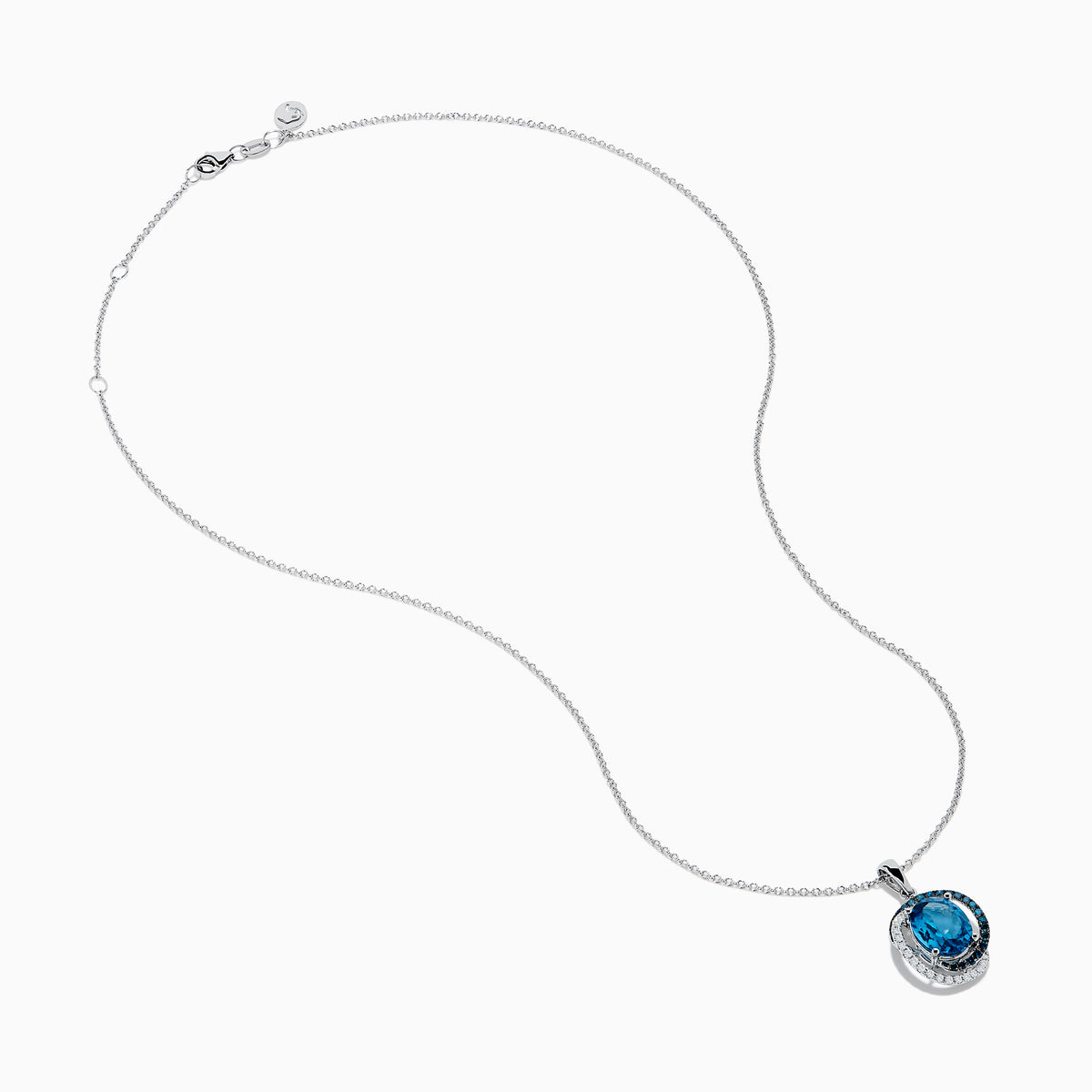 The Ocean Bleu 14K White Gold Pendant features a large blue topaz accented with swirling halos of blue and white diamonds, creating an elegant and eye-catching design.