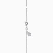 The Ocean Bleu 14K White Gold Pendant features a large blue topaz accented with swirling halos of blue and white diamonds, creating an elegant and eye-catching design.