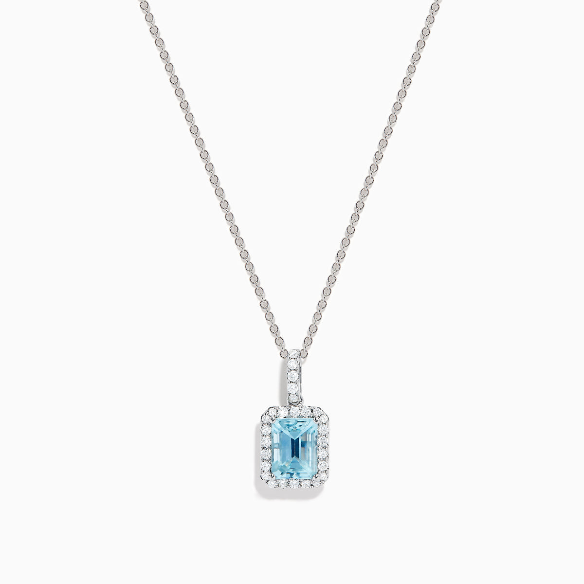 The Aquarius 14K White Gold Aquamarine and Diamond Halo Pendant features a rectangular faceted aquamarine surrounded by a sparkling diamond halo, elegantly suspended from a fine white gold chain.