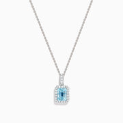 The Aquarius 14K White Gold Aquamarine and Diamond Halo Pendant features a rectangular faceted aquamarine surrounded by a sparkling diamond halo, elegantly suspended from a fine white gold chain.
