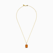 The Sunset 14K Yellow Gold Citrine and Diamond Halo Pendant showcases a rectangular citrine surrounded by sparkling diamonds, set in 14K yellow gold and displayed on a white background.