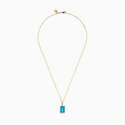 The 14K Yellow Gold Blue Topaz and Diamond Pendant features a large emerald-cut blue topaz accented by a vertical row of sparkling white diamonds for an elegant, polished look.