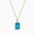 The 14K Yellow Gold Blue Topaz and Diamond Pendant features a large emerald-cut blue topaz accented by a vertical row of sparkling white diamonds for an elegant, polished look.