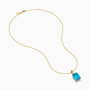 The 14K Yellow Gold Blue Topaz and Diamond Pendant features a large emerald-cut blue topaz accented by a vertical row of sparkling white diamonds for an elegant, polished look.