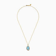 A 14K yellow gold pendant necklace featuring a sky blue topaz and mother of pearl doublet, displayed against a plain white background.