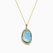 A 14K yellow gold pendant necklace featuring a sky blue topaz and mother of pearl doublet, displayed against a plain white background.