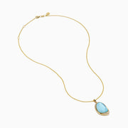A 14K yellow gold pendant necklace featuring a sky blue topaz and mother of pearl doublet, displayed against a plain white background.