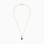 The 14K Yellow Gold Rhodolite and Diamond Pendant features a teardrop-shaped rhodolite, an elegant intertwined design, and is accented by a curved row of small diamonds.
