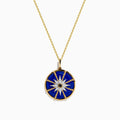 A 14K yellow gold pendant featuring a round blue lapis stone with a white and black diamond compass design—a striking addition to your jewelry collection.