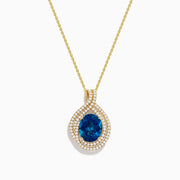 The Ocean Blue 14K Gold London Blue Topaz and Diamond Pendant features an oval-shaped topaz with a diamond teardrop design, accented by two rows of sparkling white diamonds.