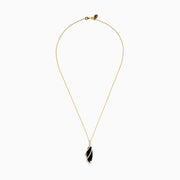 The Eclipse 14K Yellow Gold Onyx and Diamond Pendant features a teardrop-shaped black onyx wrapped in spiraling gold, accented with sparkling diamonds, and suspended from a 14K yellow gold chain.