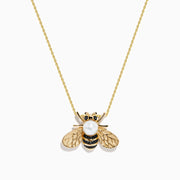 A 14K yellow gold necklace features a bee-shaped pendant adorned with black diamond and freshwater pearl, displayed on a plain white background.