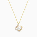 The Pearl 14K Yellow Gold Pearl and Diamond Ribbon Necklace features a white pearl encircled by two gold loops set with sparkling diamonds, shown against a plain white background.