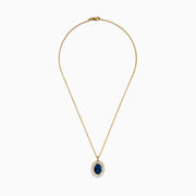 The 14K Yellow Gold London Blue Topaz and Diamond Double Halo Pendant features an oval London Blue Topaz and sparkling white diamonds, set on a gold chain necklace.