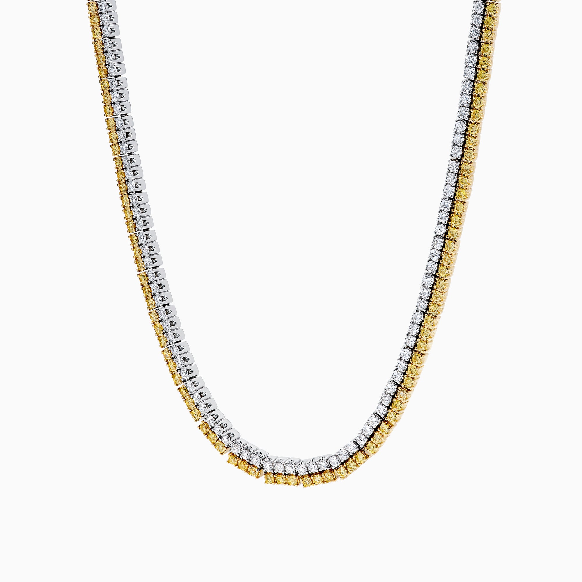 A close-up of the Canare 18K Two-Tone Gold Yellow and White Diamond Necklace features dual gemstone rows—one gold, one silver—in a curved U shape, highlighting its elegant two-tone design against a white background.