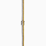 A close-up of the Canare 18K Two-Tone Gold Yellow and White Diamond Necklace features dual gemstone rows—one gold, one silver—in a curved U shape, highlighting its elegant two-tone design against a white background.