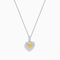 The 18K Two Tone Gold GIA Certified Yellow and White Diamond Heart Pendant features a radiant yellow center diamond surrounded by sparkling white diamonds, blending elegant charm with timeless beauty.