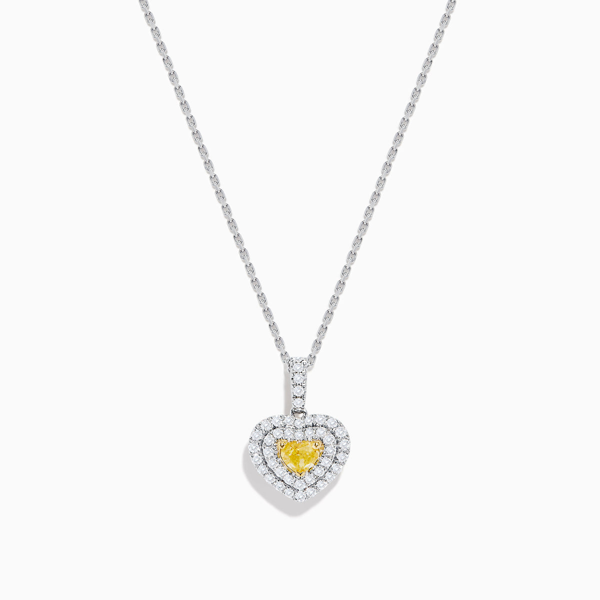 The 18K Two Tone Gold GIA Certified Yellow and White Diamond Heart Pendant features a radiant yellow center diamond surrounded by sparkling white diamonds, blending elegant charm with timeless beauty.