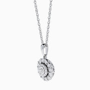 The Sterling Silver Diamond Cluster Pendant showcases a round center diamond encircled by two halos of smaller diamonds, all set in sterling silver, and is displayed on a white background.