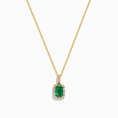 The Brasilica 18K Yellow Gold Emerald and Diamond Pendant features an emerald-cut green gemstone surrounded by small diamonds, showcased on a chain against a plain white background.