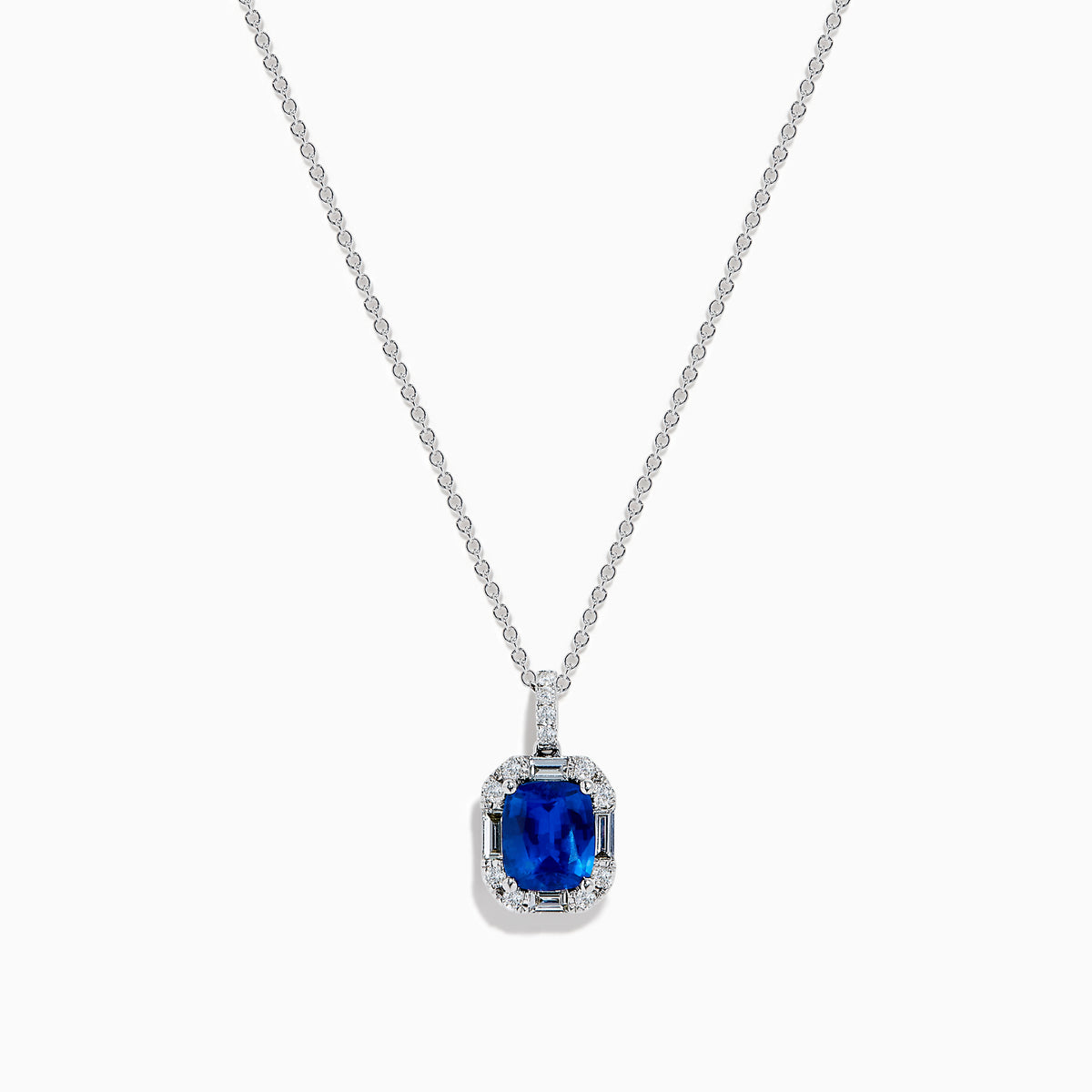 The Effy Hematian 18K White Gold Sapphire and Diamond Halo Pendant features a cushion-cut deep blue sapphire surrounded by sparkling diamonds, showcased on a plain white background.