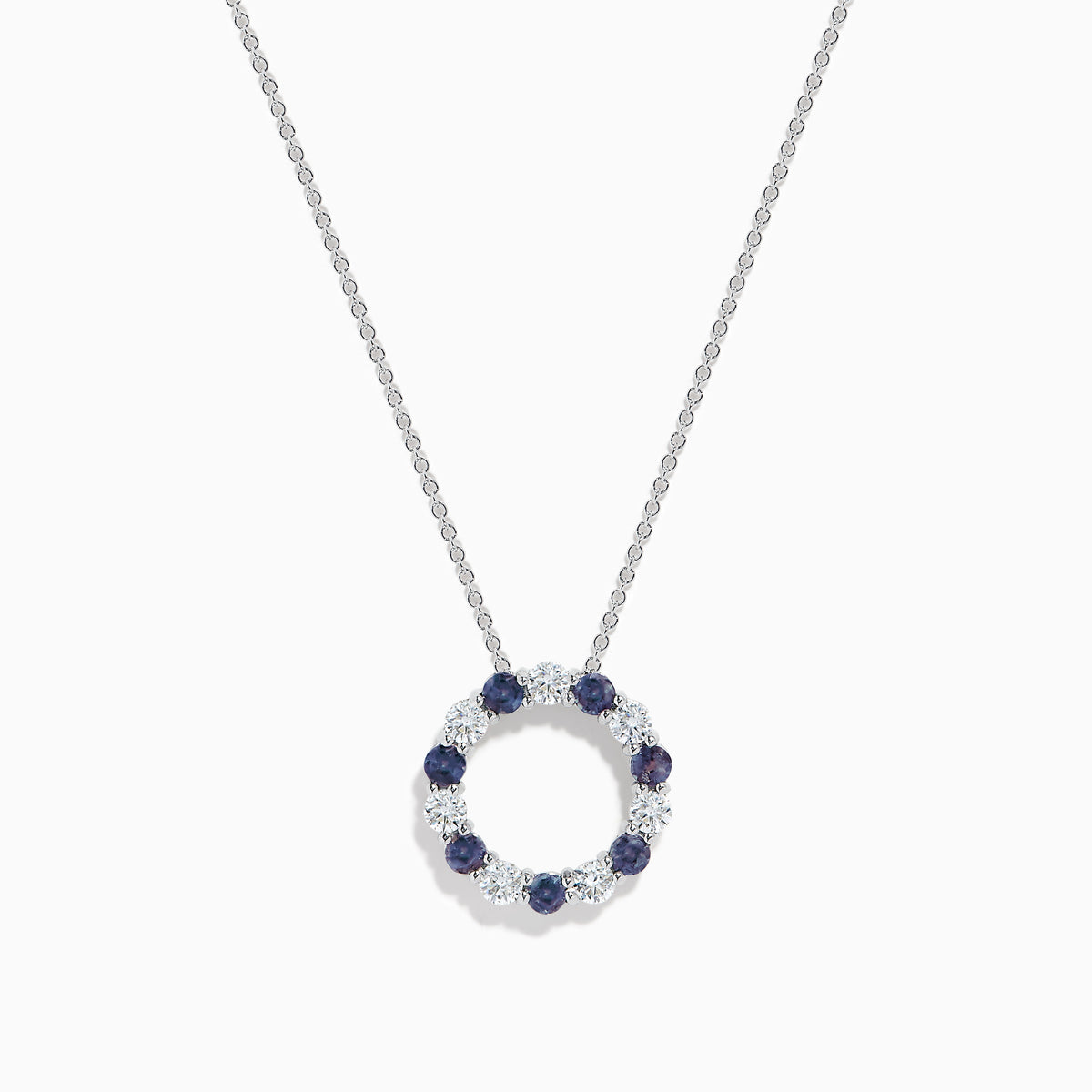 The Effy Hematian 14K White Gold Alexandrite and Diamond Circle Pendant features alternating dark blue alexandrite and clear gemstones in a circular design, shown against a plain white background.