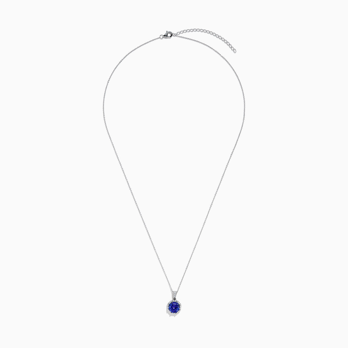 The Nahla Siri 14K Gold pendant showcases an octagon-cut tanzanite with a deep blue hue, surrounded by sparkling diamonds in a geometric setting.