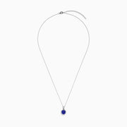 The Nahla Siri 14K Gold pendant showcases an octagon-cut tanzanite with a deep blue hue, surrounded by sparkling diamonds in a geometric setting.