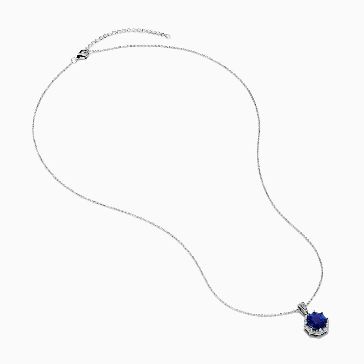 The Nahla Siri 14K Gold pendant showcases an octagon-cut tanzanite with a deep blue hue, surrounded by sparkling diamonds in a geometric setting.