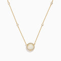The Aurora 14K Yellow Gold Opal and Diamond Necklace features a round opal pendant encircled by diamonds, with extra diamond accents on the chain—an elegant accessory for any occasion.