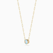 The 14K Yellow Gold Aquamarine Bezel Paperclip Chain Pendant features a round light blue aquamarine in a simple gold bezel on a delicate paperclip chain, shown against a white background.