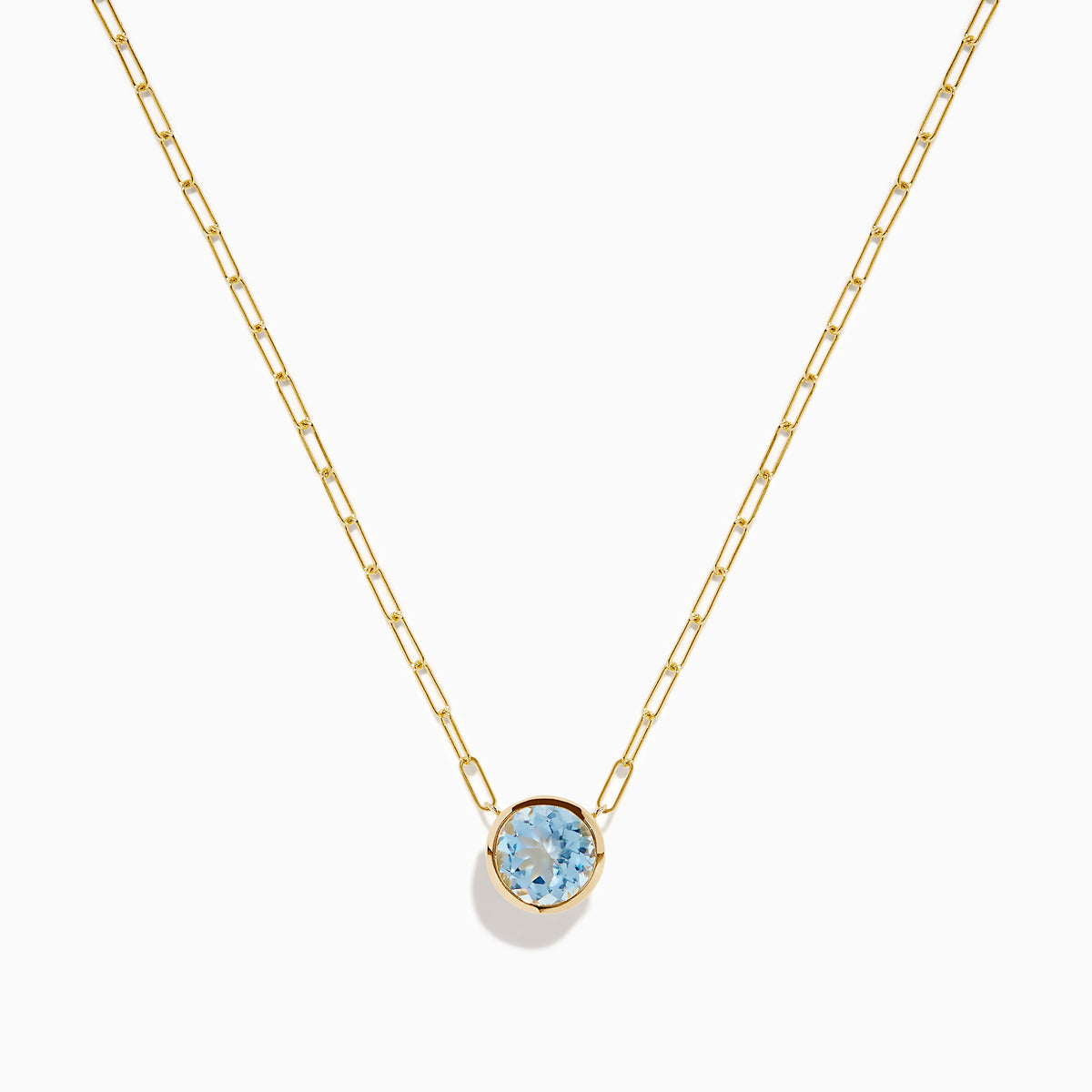 The 14K Yellow Gold Aquamarine Bezel Paperclip Chain Pendant features a round light blue aquamarine in a simple gold bezel on a delicate paperclip chain, shown against a white background.