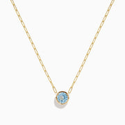 The 14K Yellow Gold Aquamarine Bezel Paperclip Chain Pendant features a round light blue aquamarine in a simple gold bezel on a delicate paperclip chain, shown against a white background.
