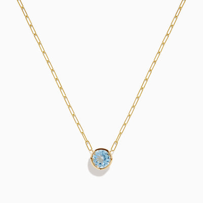 The 14K Yellow Gold Aquamarine Bezel Paperclip Chain Pendant features a round light blue aquamarine in a simple gold bezel on a delicate paperclip chain, shown against a white background.