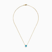 The 14K Yellow Gold Blue Topaz Bezel Paperclip Chain Pendant features a single round blue topaz gemstone on a gold paperclip chain, beautifully displayed against a white background.