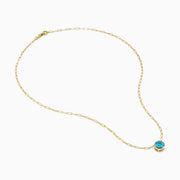 The 14K Yellow Gold Blue Topaz Bezel Paperclip Chain Pendant features a single round blue topaz gemstone on a gold paperclip chain, beautifully displayed against a white background.