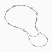 The 14K White Gold 36 Inch 3.00ct Diamond Station Necklace features a white gold chain with evenly spaced round bezel-set diamonds for a timeless, elegant look.