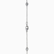 The 14K White Gold 36 Inch 3.00ct Diamond Station Necklace features a white gold chain with evenly spaced round bezel-set diamonds for a timeless, elegant look.