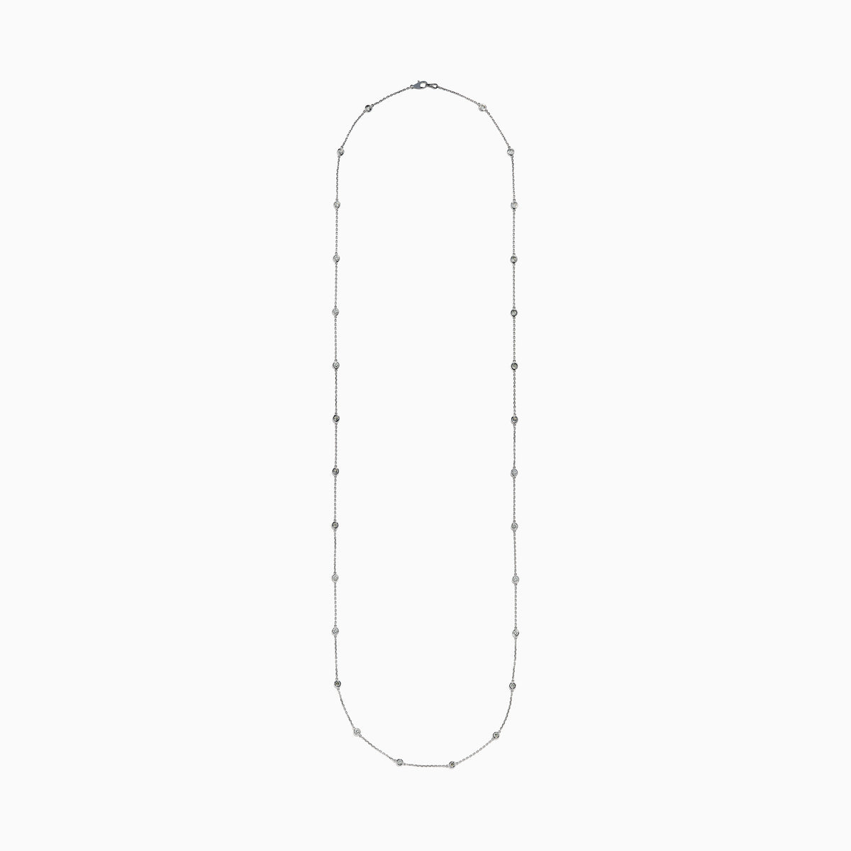 The 14K White Gold 36 Inch 3.00ct Diamond Station Necklace features a white gold chain with evenly spaced round bezel-set diamonds for a timeless, elegant look.