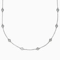 The 14K White Gold 36 Inch 6.00ct Diamond Station Necklace features evenly spaced round bezel-set diamonds along a fine chain, elegantly displayed on a white background.