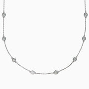 The 14K White Gold 36 Inch 6.00ct Diamond Station Necklace features evenly spaced round bezel-set diamonds along a fine chain, elegantly displayed on a white background.