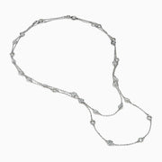 The 14K White Gold 36 Inch 6.00ct Diamond Station Necklace features evenly spaced round bezel-set diamonds along a fine chain, elegantly displayed on a white background.