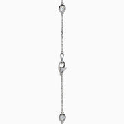 The 14K White Gold 36 Inch 6.00ct Diamond Station Necklace features evenly spaced round bezel-set diamonds along a fine chain, elegantly displayed on a white background.