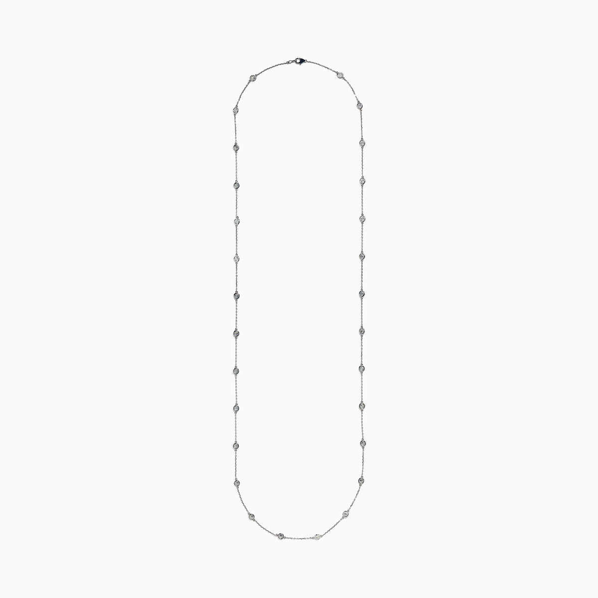 The 14K White Gold 36 Inch 6.00ct Diamond Station Necklace features evenly spaced round bezel-set diamonds along a fine chain, elegantly displayed on a white background.