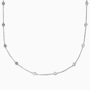 The 14K White Gold Diamond Station Necklace, 1.00 TCW, features evenly spaced round diamonds along a fine chain and is secured with a lobster clasp.
