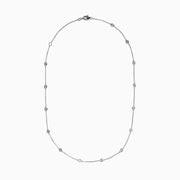 The 14K White Gold Diamond Station Necklace, 1.00 TCW, features evenly spaced round diamonds along a fine chain and is secured with a lobster clasp.