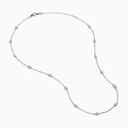 The 14K White Gold Diamond Station Necklace, 1.00 TCW, features evenly spaced round diamonds along a fine chain and is secured with a lobster clasp.