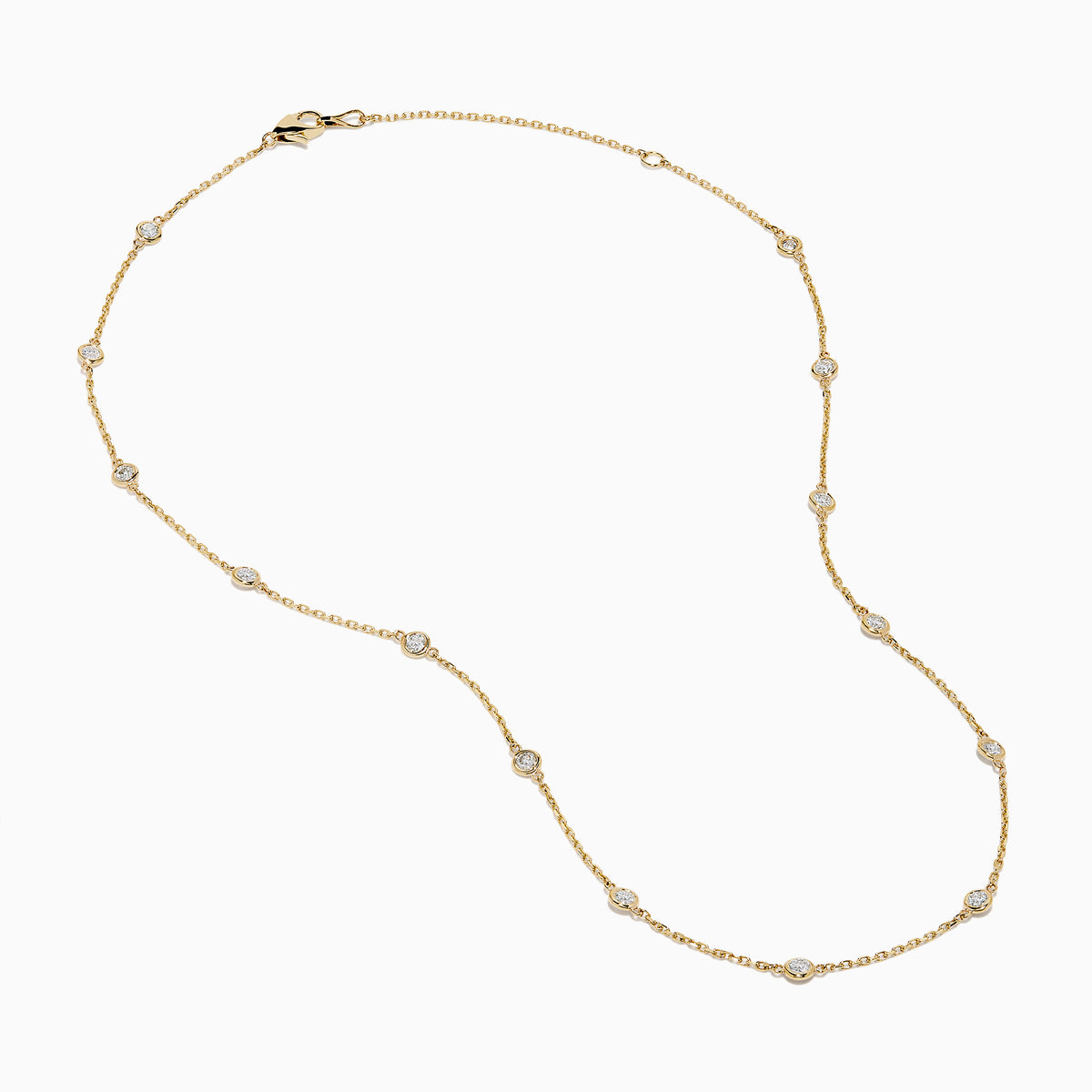 The 14K Yellow Gold Diamond Station Necklace, 1.00 TCW, features evenly spaced round diamonds in bezel settings on a delicate gold chain, shown elegantly against a white background.